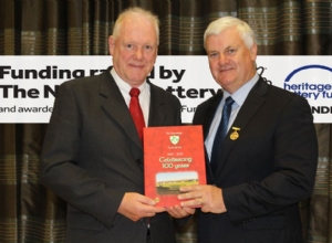 CHAIRMAN JOHN CAMPBELL PRESENTING THE GAA PRESIDENT WITH THE LOUGHGIEL CENTENARY BOOK funded by the Hertiage Lottery Fund